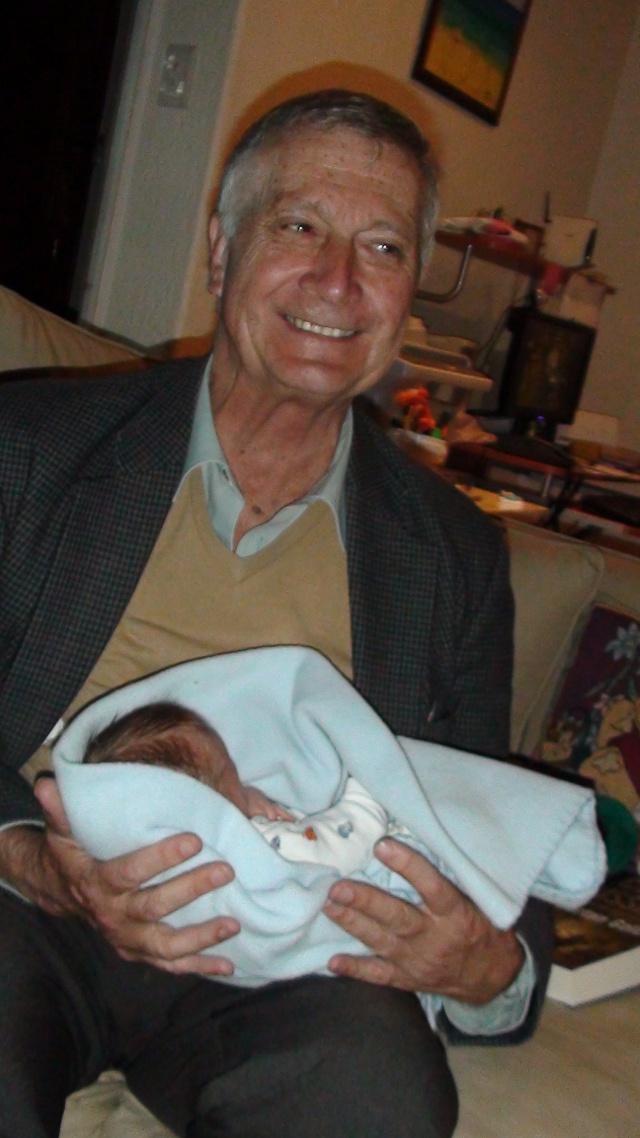 Here's on proud Granddad holding his 9th grandchild